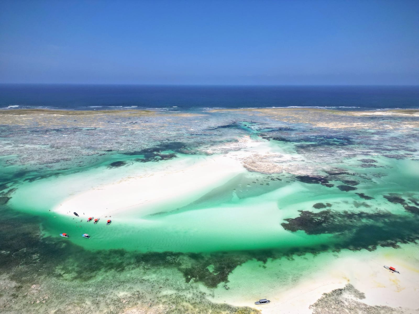 A pale sandbank exposed at low tide in the lagoon off Zanzibar's east coast, seen from the air