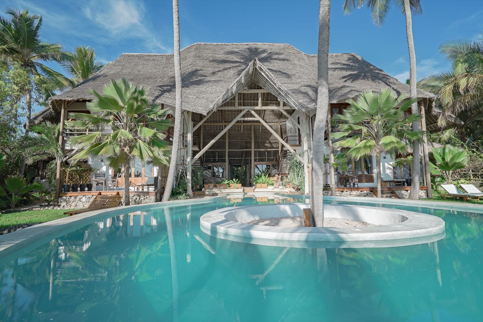 Asili House — the palm-leaf roof villa above its oceanfront pool