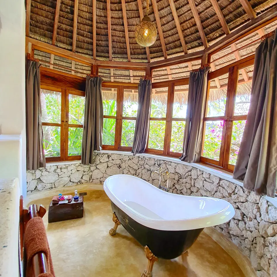 Claw-foot bathtub in Room Dunia at Asili House, Boutique Hotel Matlai Zanzibar, with design and ocean view.