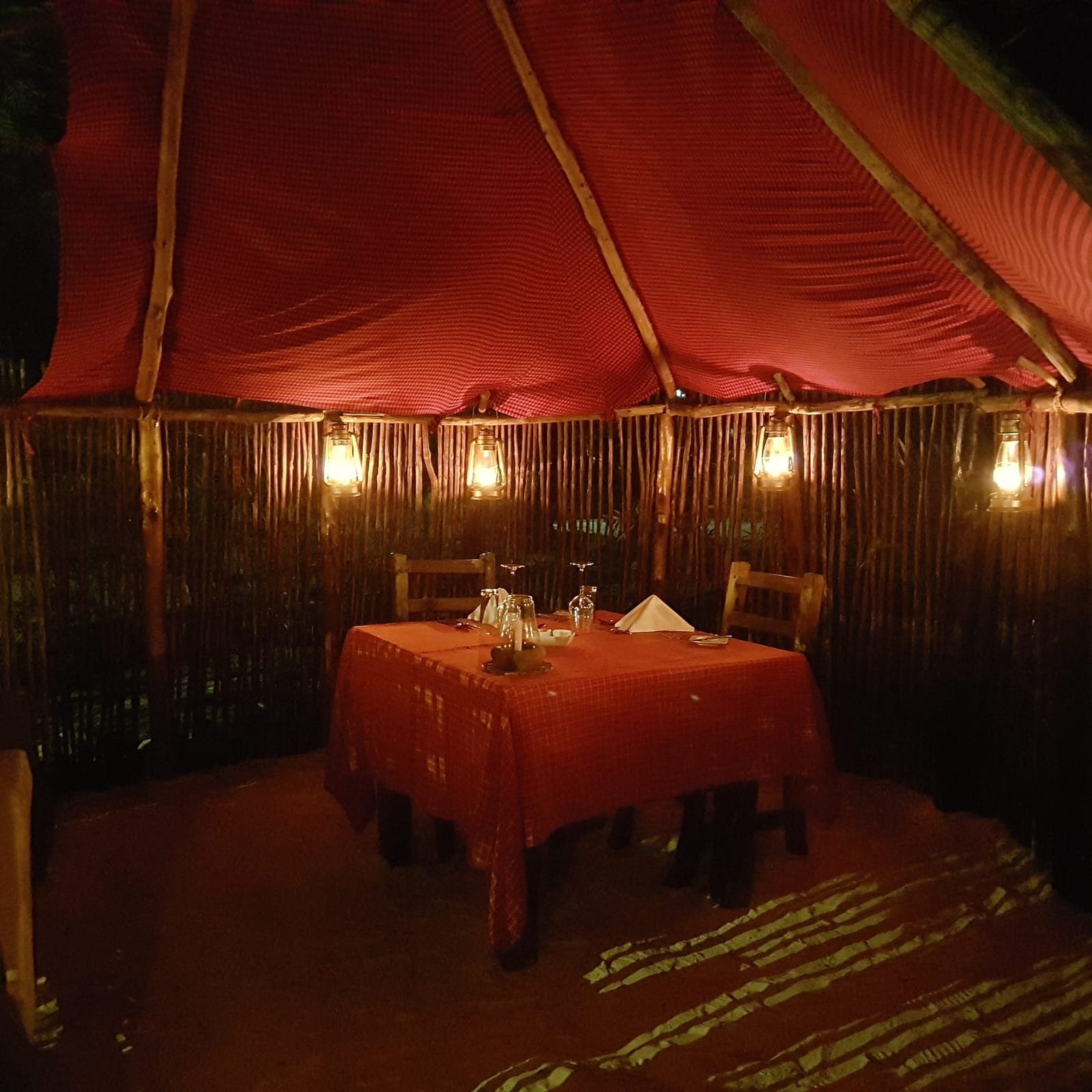 Ein zum Abendessen gedeckter Tisch im Garten bei Nacht
