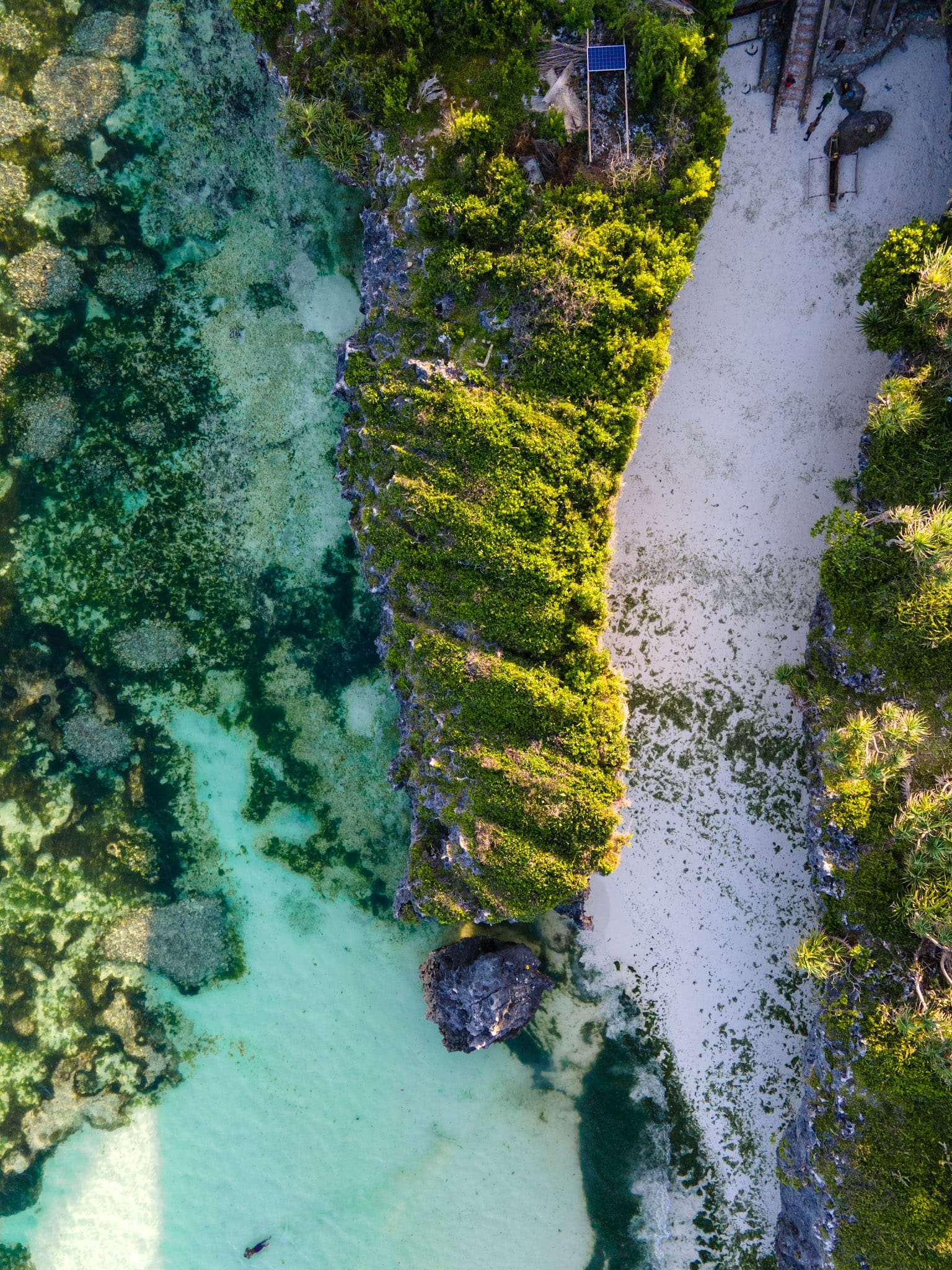 Aerial view of a turquoise Zanzibar lagoon behind the reef, the flat water kitesurfers use